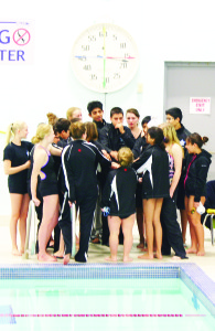 Swimmer Aran Pourawal is seen leading a team cheer.