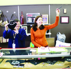 UP FOR AUCTION Caledon Community Services had plenty of items on the auction block recently at their ReUstore and Chez Thrift in Bolton. Darlene Abela of Chez Thrift was holding up some of the items while CCS Board Chair Carine Strong looked for bids. Photo by Bill Rea