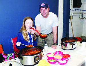 There was lots of great food, and probably a certain amount of indigestion Saturday as the Cheltenham Fire Hall was the scene of the sixth annual Chili Show Down in support of the Heart and Stroke Foundation. A number of families and community groups were offering their own particular recipes and mixtures in support of the cause. It was a family affair at this table as Sydney Lynch, 9, served up Syd's Chili Tacos, while her father Captain James Lynch offered seafood chili, which ended up taking top prize.