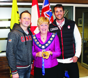 Mayor Marolyn Morrison got to hold the Olympic Gold Medal belonging to Caleb Flaxey (left) at Tuesday's ceremony at Town Hall. Also on hand was Olympic snowboarder Jake Holden. Photo by Bill Rea