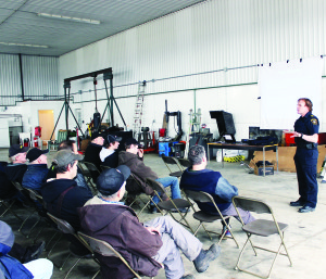 FARMERS HEAR ABOUT RULES OF ROAD A group of area farmers gathered Saturday at Bill Hewson's Shop on McLaughlin Road to get some information regarding the rules of the road, particularly as they apply to agricultural vehicles. Sergeant Hank DuVee of the enforcement section of the Ministry of Transportation, was delivering the talk, which covered a variety of topics, including farm vehicle safety, load security, distracted driving, classes of driver's licences, etc. Photo by Bill Rea