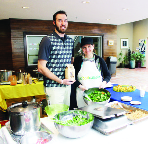 EARTH DAY MARKED Tuesday was Earth Day and it was celebrated at Town Hall by Eat Local Caledon. Blake Smith, a co-op student with the Town's energy and environment department, and Karen Hutchinson of Eat Local Caledon were serving up locally-grown food at lunch time in the foyer. Photo by Bill Rea