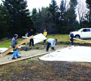THE RINK COMES DOWN Spring must be at hand, because the skating rink at the Caledon Fairgrounds has been dismantled. Volunteers were out Friday to take the rink apart. Seen here hard at work are Mike McCormick, Ian Sinclair, Don DiStasi, Craig Simpson. Tim Forster and Glenda Simeone. Photo by Bill Rea