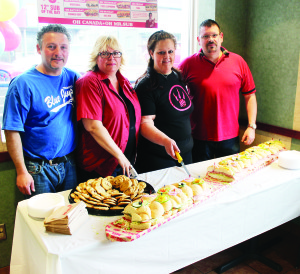 MR. SUB HAS RESURFACED The Mr. Sub shop at the corner of Sterne and Queen Streets in Bolton has reopened for business after renovations, and the proprietors and management of the outlet recently celebrated with this six-foot sub. Seen here are Dino Tamburini, Shelley Bartley, Nada Pileggi and Brad Bartley helping to serve up chunks of the sub. Photo by Bill Rea