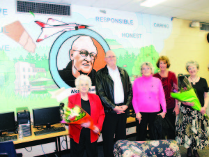 Alex Raeburn's son John, sister Isabel Bospoort and daughter Lynn Baker were flanked by Joan Kadoke and Fay McCrea, the organizers of last week's event, in front of the mural on the wall of the newly renamed library at Caledon Central Public School.