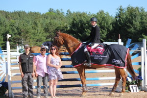 Edmonton's Jaclyn Duff accepted the top prize in the Sierra Excavating Enterprises Cup competition, aboard Stakkaru. The presentation was made by Dominic Scrivo, owner of Sierra Excavating, which built the new facilities at Caledon Equestrian Park in just 96 days, starting in February. He was accompanied by his wife Denise and son Justin.