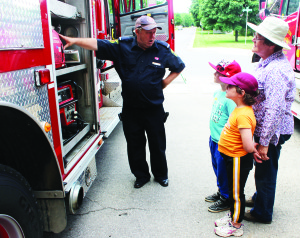 MUCH TO LEARN AT FIRE HALL The Caledon East Fire Hall hosted an open house Saturday, giving the public the chance to get a closer look at the equipment used locally in emergencies. Training Instructor Brian Littler was showing some of the equipment to Caledon East resident Flo Frizza and her grandchildren Romano, 8, and Emma, 6, Vitkovskyi, who were visiting from Brampton. Photo by Bill Rea