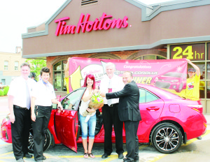 Patricia Giorgio accepted the keys for her new car from Bolton Toyota General Sales Manager Mike Rietta, accompanied by Bolton Tim Hortons proprietors Brad Stafford, his wife Liz and his father Barry.