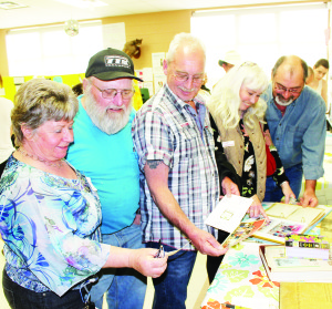 It was a packed house on hand recently for the celebration of the 50th anniversary of Belfountain Public School. her Karen Smith was looking over memorabilia with former students George Foster, Lorne Foster, Cathy (Foster) Earle and Wally Foster.