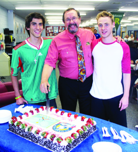HUMBERVIEWS PRINCIPAL RETIRES Students at Humberview Secondary School closed out the school year recently by holding a reception in the library for retiring principal Rick Tredwell. SAC Presidents Stefano Martelli and Reid Clark assisted him in the cutting of this cake. “I'm going to play a lot of tennis and do a lot of fishing,” Tredwell said, adding he and his wife plan to take cruises. He's been principal at Humberview for seven years, coming after seven years as vice-principal at TL Kennedy Secondary School in Mississauga. “I've always philosophized that the students here kept me young,” he said Photo by Bill Rea