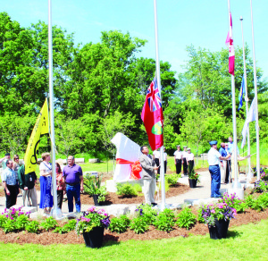 Various dignitaries were in position for the ceremonial raising of the flags at Saturday's opening of the Rotary Club of Bolton's Peace Park. Photos by Bill Rea