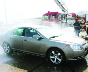 FIREFIGHTERS' CAR WASH WAS SUCCESSFUL Caledon Fire and Emergency Services ninth-annual Muscular Dystrophy fundraiser car wash was a huge success. Firefighters Debbie Martin of the Bolton station was one of the personnel on duty to wash the cars in the Bolton Canadian Tire parking lot. This year, they raised $2,000.  Photo by Bill Rea