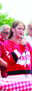 Caledon village resident Maddey Winters, 11, led the singing of O Canada at the Strawberry Festival.