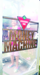 Canadian Tire was one of the sponsors of the annual Canada Day celebrations at Albion Hills Conservation Area, and they were running a Fun Zone on the grounds. One of the attractions there was this Money Machine, and Kayla Blanda, 9, of Brampton was trying to catch all the Canadian Tire coupons she could as they blew all around her.
