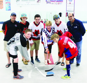Mayor Marolyn Morrison dropped the ceremonial first ball in the recent 2014 Ontario Ball Hockey Federation (OBHF) Atom/Peewee Provincial Minor Championships. Brandon Hillier of the Milton Mad Men and Shane Thrower of the atom Caledon Bulldogs took the faceoff. Morrison was flanked by Dave Eccleston and Frank Rocca of the host Bulldogs and Under-16 Team Canada members Ryan Nicholson, Daniel Heelers and Ryan Eccleston. Photo by Bill Rea