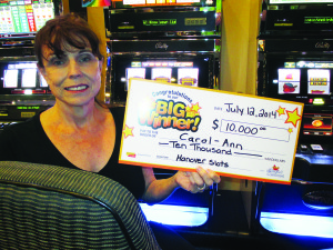 BOLTON WOMAN WINS AT SLOTS Bolton resident Carol Bryan won a $10,000 jackpot with Triple Blazing 7s during a visit to OLG Slots at Hanover Raceway Saturday. “It's unbelievable!” Bryan declared shortly after her big win. “Someone else had to tell me that I won a big jackpot. I didn't believe it until I saw the figures on the machine.” She was in the area visiting old friends who live in Markdale. She plans to spend some of her winnings on her grandchildren and support one of her favourite charities. “I'll also be treating my friends to dinner,” she added. “It's always exciting when our patrons win big jackpots,” said Spencer Parazader, general manager at OLG Slots at Hanover Raceway. Photo submitted