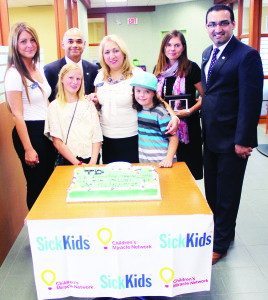 Those taking part in Tuesday's ceremonies at the Bolton branch of TD Canada Trust included Branch Team Leader Marie Pinto, District Vice-President George Mathew, SickKids Patient Ambassador Colena Johnson, Branch Manager Marisa Kennedy, Jakob Gutt, Cheryl Boston and District Vice-President Faisal Yousuf. Photo by Bill Rea