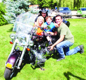 Crowd was out to Chase the Dream There was lots of activity, along with an impressive display of motorcycles, Sunday at Terra Cotta Inn for the third annual Chase the Dream. The event is held in support of Chase Galea, a local seven-year-old boy with cerebral palsy and hearing loss. Chase is seen here with his mother Rachel, sister Paige and father Shawn. They were sitting on this Heritage Harley Softtail belonging to Pena Baldassi of Toronto. Photos by Bill Rea
