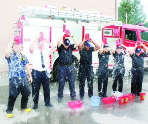 Caledon Fire Chief David Forfar (second from left) was among other local fire personnel taking part in the Ice Bucket Challenge. Seen here, also getting drenched, are Fire Prevention Officer Scott Gilbert, Fire Prevention Officer Dave Pelayo, Administration Assistant Debbie Martin, Public Education Officer Gillian Boyd, Administration Assistant Dawn Rowley, and Administration Assistant Cathy Richards. Photo by Bill Rea