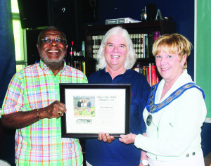 King's College School Managing Director and Co-founder John Eta and Founder and Principal Barbara Lord accepted this plaque from Mayor Marolyn Morrison in honour of the school's 20th Anniversary. Photo by Bill Rea