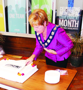 Mayor Marolyn Morrison helped cut the cake at Tuesday's staff appreciation event at Town Hall.