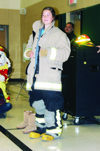 Caledon Fire and Emergency Services chose SouthFields Village Public School as the place to kick off Fire Prevention Week Monday. Fire Chief Dave Forfar urged the student to ask their parents for smoke alarms in their bedrooms. The celebrations included students trying on firefighting gear. Brooklyn Stephenson was posing with her outfit, while Firefighter Jesse Newcombe was assisting Tyrell Campbell. Photos by Bill Rea