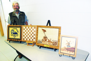 Ken Perch shows some of his marquetry creations.