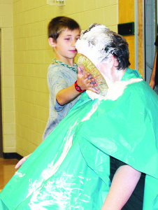 PIE IN PRINCIPAL'S FACE Palgrave Public School student Gradon Knox learned there are certain rewards to raising money. He was the top junior school fundraiser in the recent Terry Fox Run, and his reward was being given the honour of plunking this pie in the face of Principal Julia Breen Friday. He wasn't the only one. Turn to page A10 for more information. Photo by Bill Rea