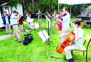 Melville Church hosts tea There was a good crowd out recently for the fourth annual Tea Party at Melville White Church near Belfountain. Zack Ebin or Etobicoke Suzuki Music was leading these young folks in performing some music appropriate to the setting. Photos by Bill Rea