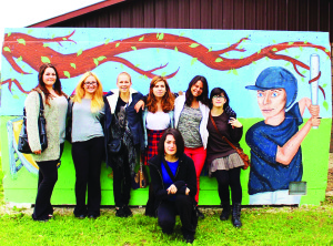 ART STUDENTS PAINT MURAL FOR BALL DIAMONDS Students from the visual arts program at St. Michael Catholic Secondary School in Bolton recently painted a mural at the Bolton Heights Baseball diamonds. The mural was thought up after the students took an environmental science course. They decided to use their artistic skills to show the beauty of Bolton using symbolism in the importance of everything that makes up the village, including the Humber river, baseball diamond, a community and a tree that connects on all four sides showing that they all connect.) They also wanted to use art in the community to promote the arts program at their school. Their hope is the mural helps young artists find inspiration and keeps the community clean. Seen here are students Carly Beamish, Christina Yarascavitch, Emily Miceli, Hera Xhyheri, Nikki Arezza, Sara Boudreau and Sara Garofalo. Submitted photo