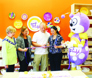 CROCK A DOODLE OPEN FOR BUSINESS Mayor Marolyn Morrison was on hand recently to help officially open Crock A Doodle in Bolton, making it one of 17 franchise outlets for the company. Melissa Elaschuk and her husband Chris cut the ribbon, assisted by Crock A Doodle founder Annette Brennan and the company mascot. The store offers a selection of pottery items that people can decorate, and then have glazed in a kiln. There are also facilities for parties and gatherings. Photo by Bill Rea