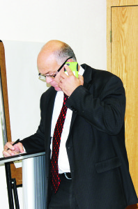 Results were slow coming into Town Hall election night, so Allan Thompson was getting information over the phone.