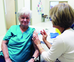 GET YOUR FLU SHOT Did you get your flu shot yet? Peel Public Health is urging residents to do that, and hosted a clinic last Wednesday at Knox United Church in Caledon village. Local resident Flora Speringett received her shot from Registered Nurse Caroline Slade of Peel Public Health. Photo by Bill Rea