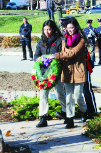Elyse Holwell and Christina McArthur laid this wreath at Town Hall on behalf of Robert F. Hall Catholic Secondary School.