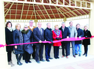 Mayor Marolyn Morrison cut the ribbon at Village Blue last Thursday. She was accompanied by Councillor-Elect Johanna Downey; Linda Robinson, sales and marketing director for Monarch Homes; Elizabeth Sawicki, vice-president of land for Monarch; Scott Arbuckle of RBI Group; Mayor-Elect Allan Thompson; David George, president of Monarch; Tom Baskerville, vice-president of development with Coscorp; Richard Costigan, vice-president of Coscorp; Ken Bokor of the SouthFields Village Residents' Group; and Kathy Armstrong, representing the Headwaters Health Care Foundation Board. Photo by Bill Rea