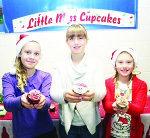 Young entrepreneurs Denele Barron, Sydney Rayner and Jocelyn Rayner were doing brisk sales at their Little Miss Cupcakes booth.