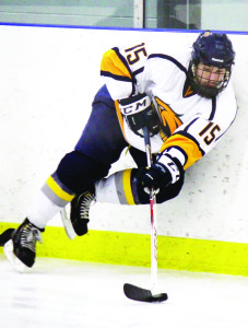 Derek Czech corrals a puck behind the Golden Hawks net on Sunday night. The Hawks won the game 7-4. Photo by Jake Courtepatte