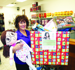 HELPING OUT WITH SANTA FUND Several local businesses are pitching in to collect new, unwrapped toys and games to contribute to Caledon Community Services' (CCS) annual Santa Fund, and Vera Robinson of Naked Vine in Bolton has been busy gathering contributions. CCS reports there are more than 150 families, including some 300 children, in need of help. Robinson said they will be accepting donations until Dec. 12. Photo by Bill Rea