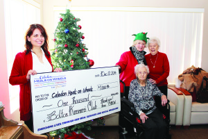 KIN SUPPORT LUNCHEONS Caledon Meals on Wheels hold Christmas luncheons for the residents of the various supportive housing buildings in town, and they recently received support from the Kinsmen Club of Bolton, to the tune of $1,000. Cathy Lepiane and Lynn Wood of Meals on Wheels are seen here with Stationview Apartments in Bolton residents Doris Hollingworth, 104, and Terry Babin. Photo by Bill Rea