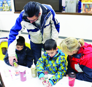Steven and Laura Aldoroty of Bolton were helping their twin boys William and Lee make snow globes.