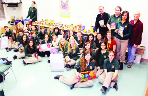 Fr. Bob Glynn and Chaplain Brenda Holtkamp joined students of Robert F. Hall Catholic Secondary School in the midst of the contributions they collected for the less fortunate.