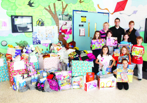 The front hall of James Bolton Public School was filled recently with contributions from the school's charitable efforts. Seen here are Principal Laurie Allison, Vice-Principal Jeremy Taylor, Samantha Di Virgilio of the Home and School Association, and students Sophia Tsitsias, Renee Favot, Sydney Bennett, Nicholas Lowther, Melina Barker, Sophie Rapallo and Taylor Robinson. Photo by Bill Rea