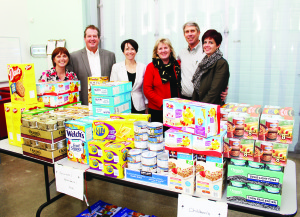 Staff at Rowland Investments in Caledon dropped off a wide assortment of food contributions at the Exchange in Bolton, helping the efforts of Caledon Community Services (CCS). The company has made annual donations to the Santa fund for more than 15 years, always matched by Manulife Financial. Kim D'Eri, manager of community animation for CCS, Event Planner Shona Lauzon and Board Member Bill Dunne accepted the contributions from Bente and Jim Rowland and Julianne Carras. One of the company's product partners will be matching the contribution. Photo by Bill Rea