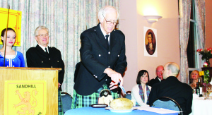 BETTER LATE THAN NEVER FOR HAGGIS It might have been a little late, but the spirit of Robbie Burns was very much alive Saturday night as the Sandhill Pipe Band hosted their second annual Robbie Burns Supper at St. James' Church in Caledon East. A small fire at the church meant the event had to be postponed a couple of weeks. Georgetown resident Dave Borrett, a member of the band, delivered the Address to the Haggis. Photo by Bill Rea