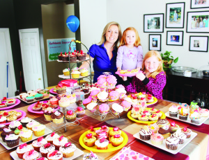CUPCAKES ANYONE? Caledon East resident Kathleen Baggio was doing a brisk business Sunday in honour of National Cupcake Day. She was assisted by volunteer helpers Maia Krick, 3, and her sister Cameron, 8. The effort raised $408 for the Orangeville chapter of the Society for the Prevention of Cruelty to Animals. The cupcakes that weren't sold were delivered to the seniors' residence on Walker Road in Caledon East. Photo by Bill Rea