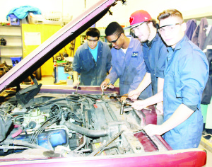 Grade 8 students planning to attend Robert F. Hall Catholic Secondary School next year and their parents got the chance to see what high school life is like for themselves recently. The school hosted its annual evening open house. One can learn how to work on cars at the school. Arjun McNeill, Kenneth Morris, Connor Craig and Giancarlo Bisante were getting ready to change the spark plugs in this 1969 Lincoln.
