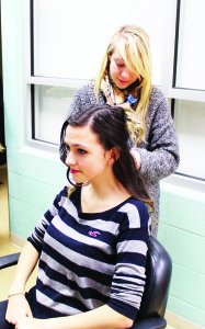 Hall Alumnus Alexandria Celebre was working with the cosmetology class, working on the hair of Grade 10 student Alayna Do Alamo.