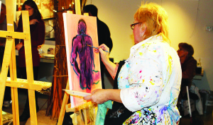 at Alton Mill Arts Centre. They had 20 minutes to complete their creations. The audience named Lynda Clare Grant (above) the winner. The other competitors were Kendra Bailey, Crystal Lori Boyd and Hilary Sher. The next Art Battle is scheduled for this Saturday at the Mill. Photos by Bill Rea