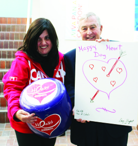 Gloria Maxx joins Councillor Doug Beffort as he holds up his heart creation.