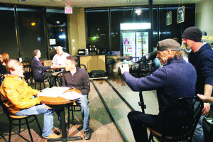 Writer and Director Nick Marciano (far right) watches as Director of Photography Tony Morrone shoots a scene in Gabe's Country Bake Shoppe in Caledon East Saturday night. The actors in the foreground are David J. Parisian and Paul Ebejer, with with Brian Bordignon and Peter Frangella at the table to the rear. Photo by Bill Rea